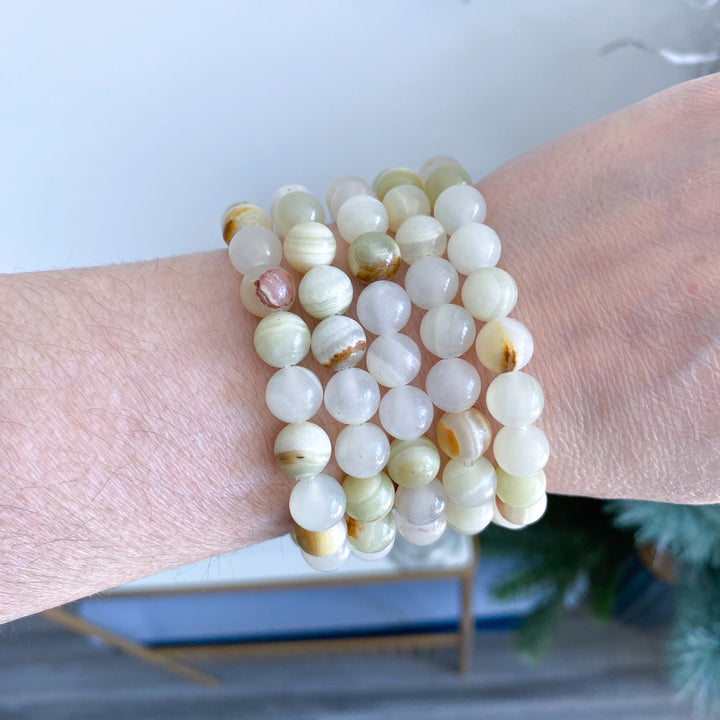 Stack of beaded bracelets on a wrist with a blurred background