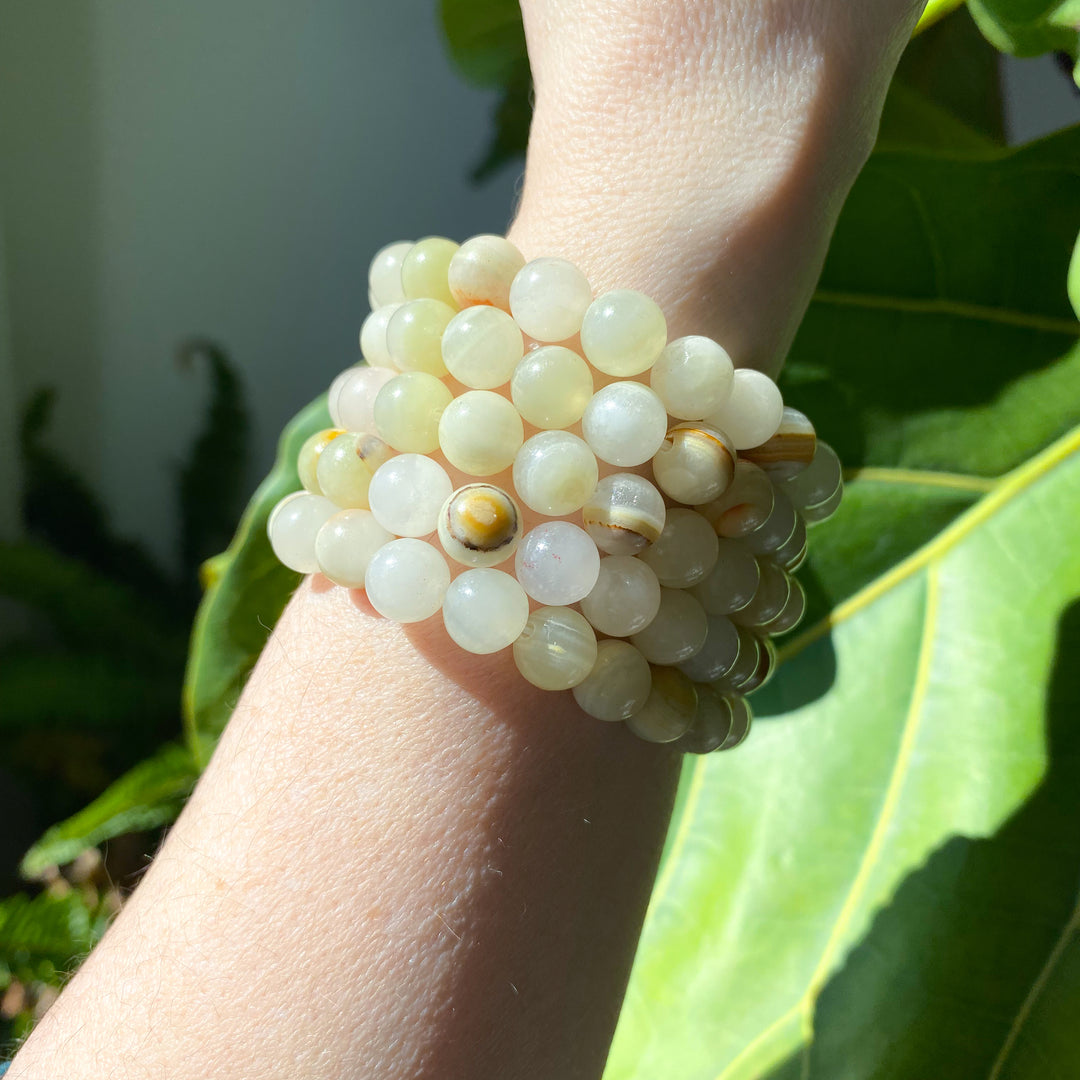 Close-up of a wrist wearing a beaded bracelet with a natural background
