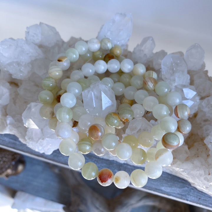 Green beaded bracelet on a crystal background