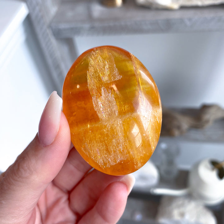 Bright, Juicy Orange Calcite Palm Stone with Rainbows #1