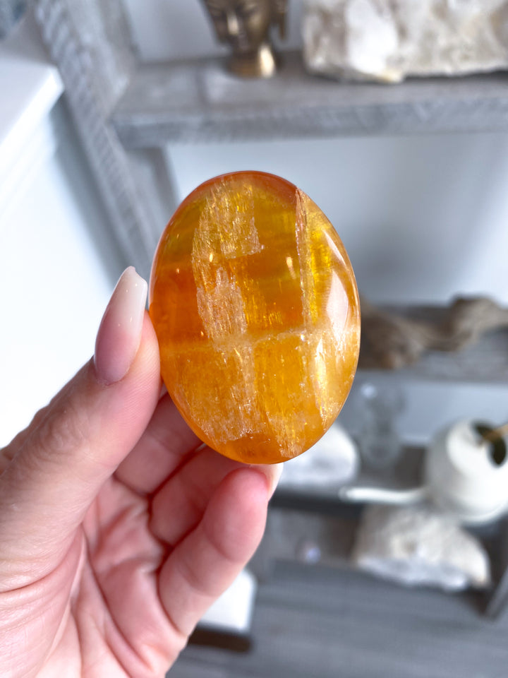 Bright, Juicy Orange Calcite Palm Stone with Rainbows #1