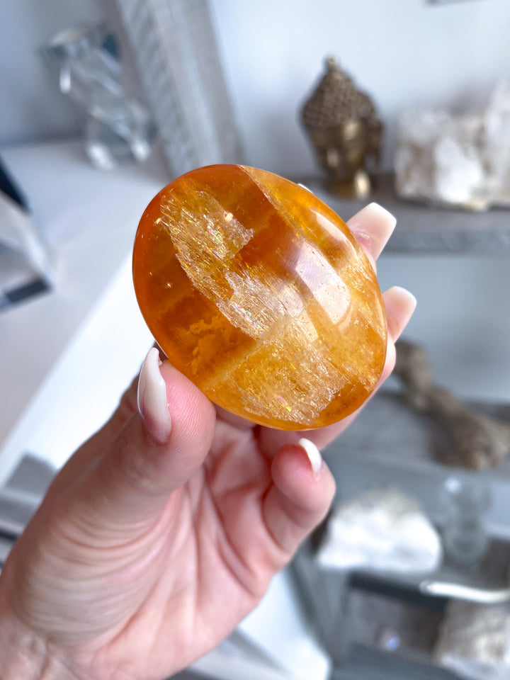 Bright, Juicy Orange Calcite Palm Stone with Rainbows #1