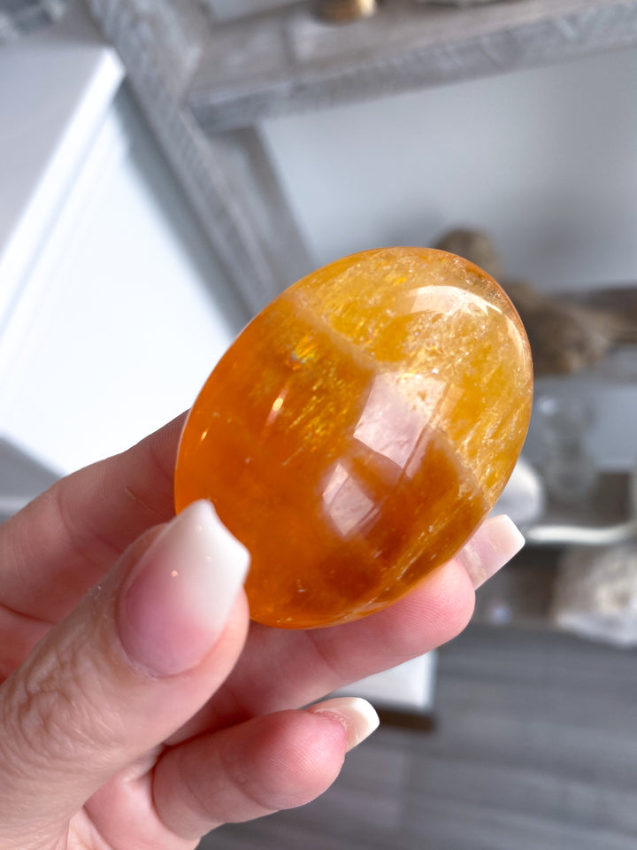 Bright, Juicy Orange Calcite Palm Stone with Rainbows #1