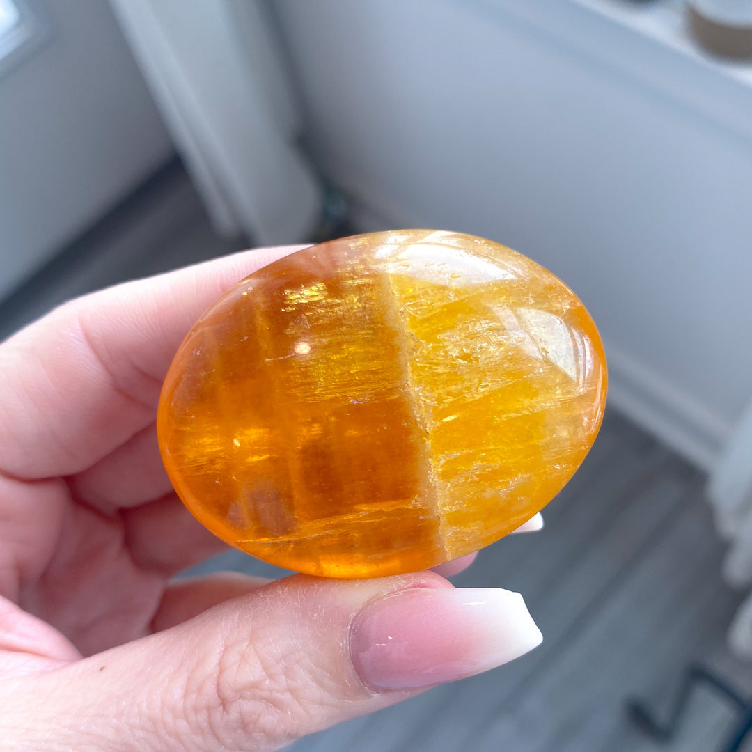 Bright, Juicy Orange Calcite Palm Stone with Rainbows #1
