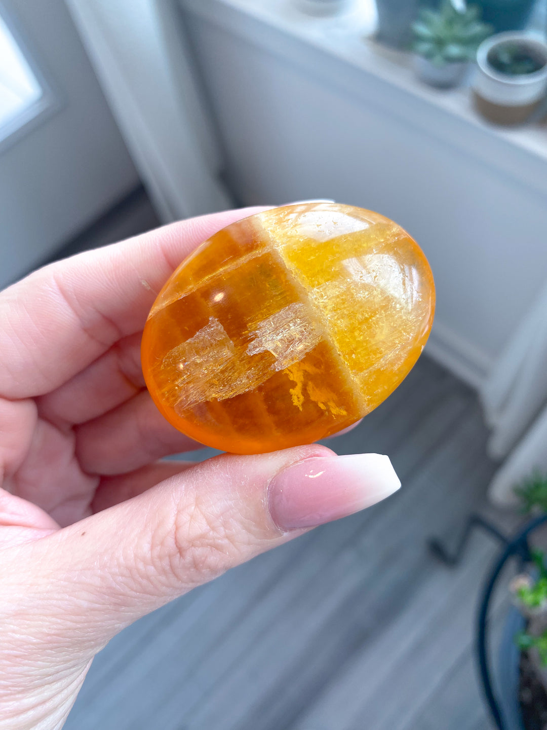 Bright, Juicy Orange Calcite Palm Stone with Rainbows #1