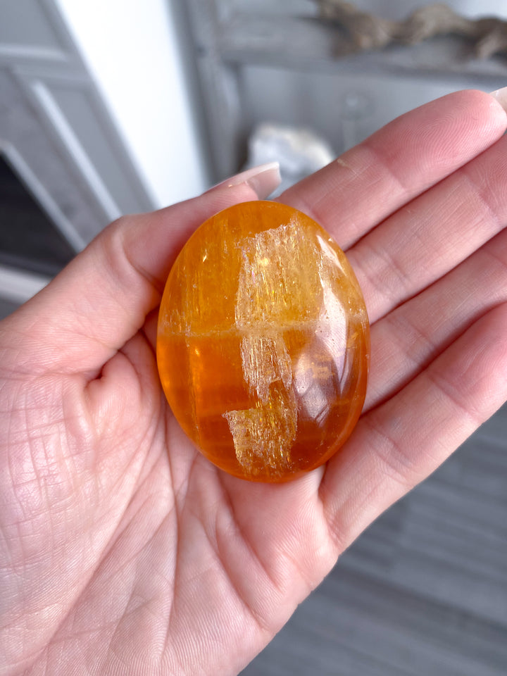 Bright, Juicy Orange Calcite Palm Stone with Rainbows #1