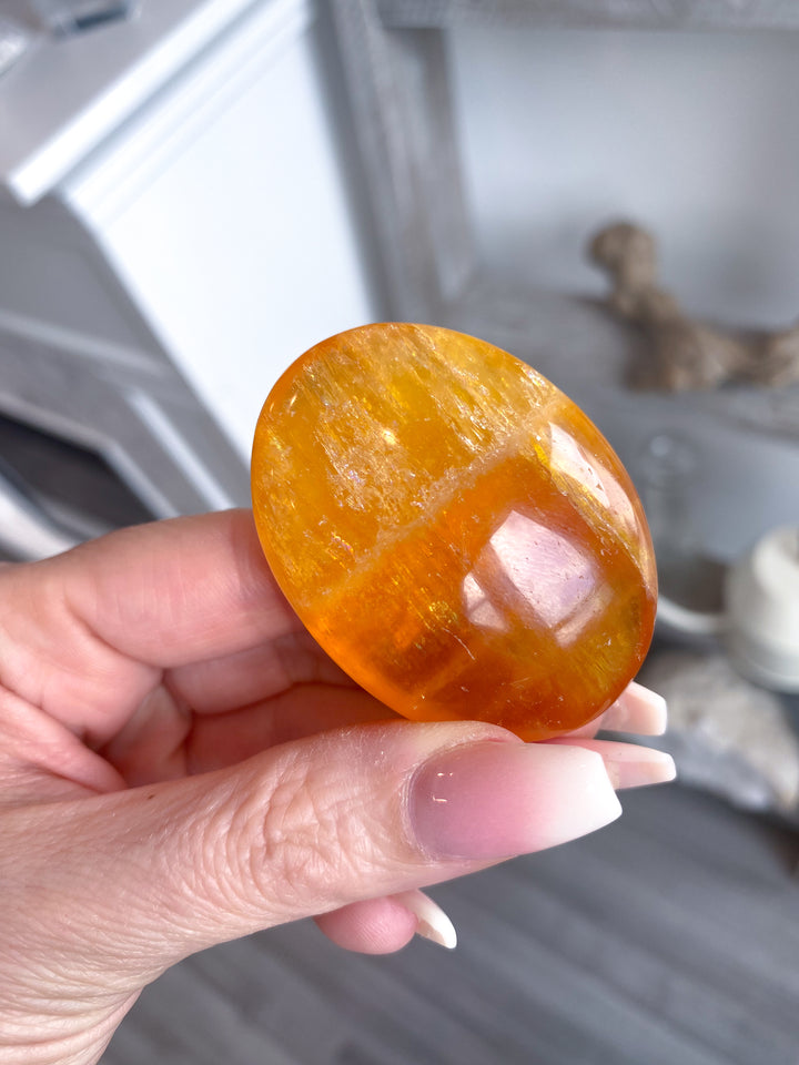Bright, Juicy Orange Calcite Palm Stone with Rainbows #1
