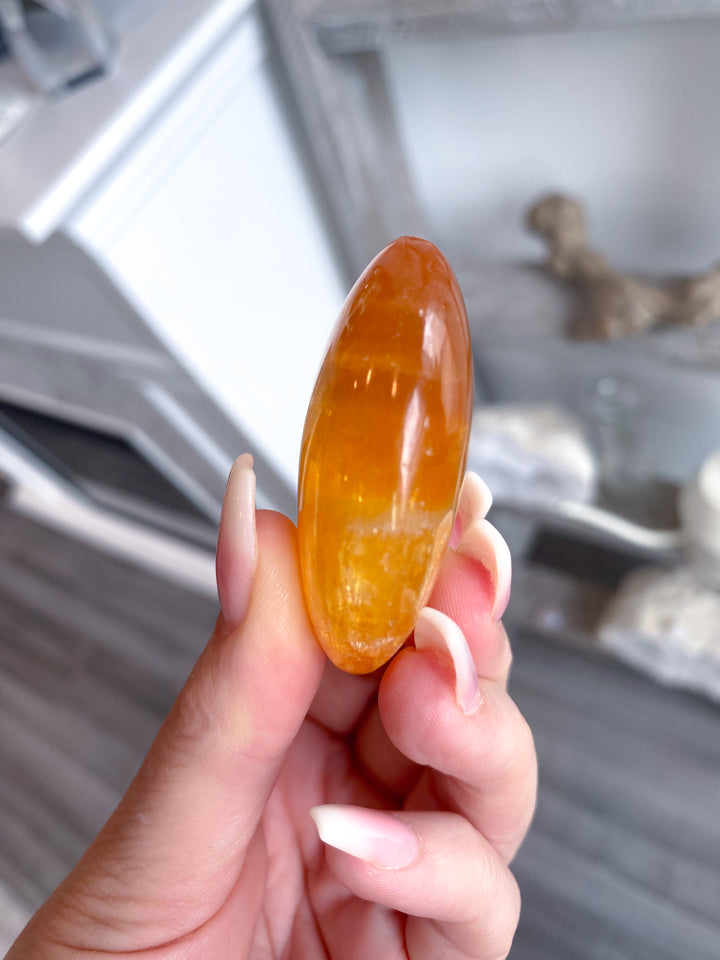Bright, Juicy Orange Calcite Palm Stone with Rainbows #1
