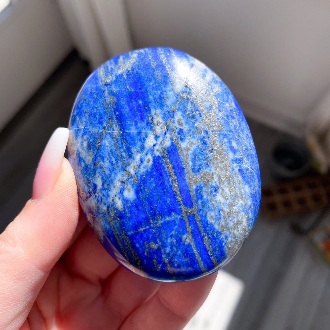 Hand holding a blue marbled stone