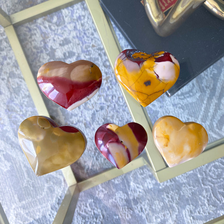 Heart-shaped marbled stones on a textured surface