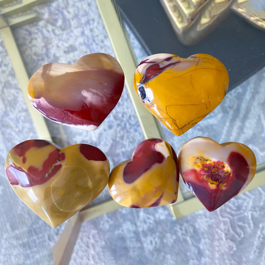 Heart-shaped marbled stones on a textured surface