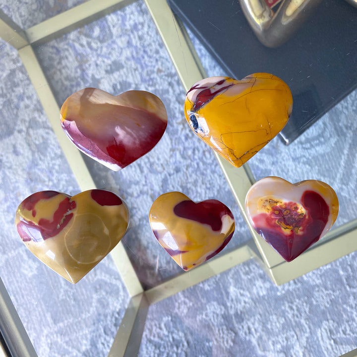 Heart-shaped marbled stones on a textured surface